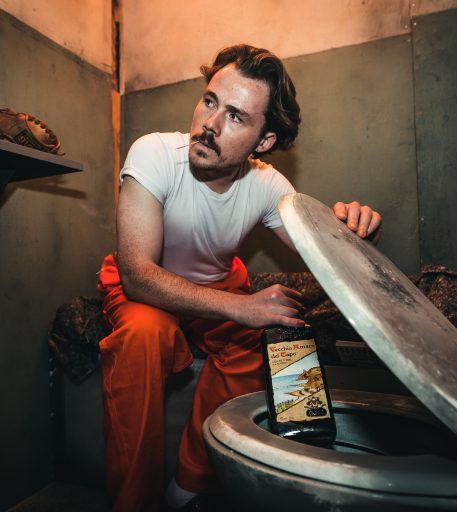 Inmate smuggling contraband alcohol into Alcotraz Brighton - key part of the immersive prison bar experience storyline.