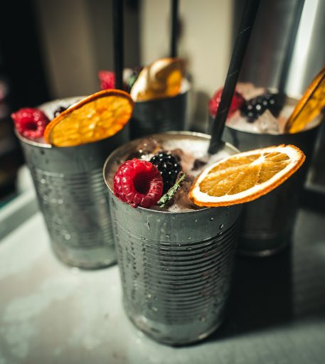 Custom cocktails with fruit garnish at Alcotraz Brighton - immersive prison-themed bar experience.