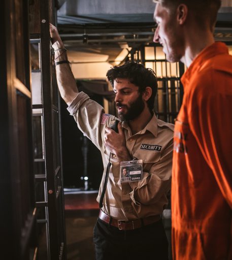 Warden character at Brighton Alcotraz - prison-themed interactive bar for fun nights out.
