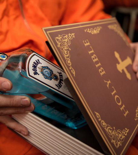 Inmate smuggling contraband alcohol into Alcotraz - immersive prison bar experience storyline.