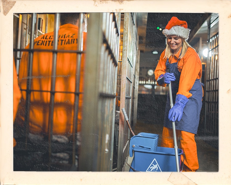 Customer in orange jumpsuit working as cleaner at Alcotraz immersive experience - interactive prison-themed cocktail bar.