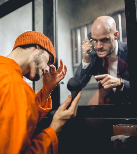 Inmate interacting with warden character at Alcotraz - authentic and immersive cocktail bar experience.