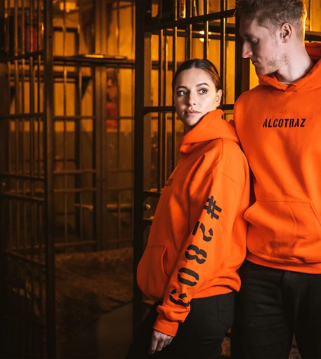 Orange inmate hoodies from Alcotraz - merchandise from this prison-themed immersive cocktail bar.