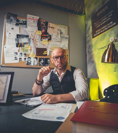 Prison warden character in cell interior at Alcotraz - detailed set design in this immersive cocktail bar experience.