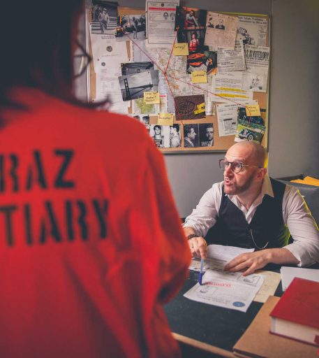 Prison guard character interacting with customers at Alcotraz - immersive cocktail bar experience.