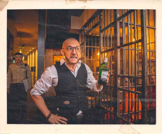 Prison warden character at Alcotraz Manchester location - immersive prison-themed cocktail bar experience.