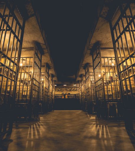 Liverpool Alcotraz venue interior - prison-themed immersive cocktail bar with authentic cell block design.