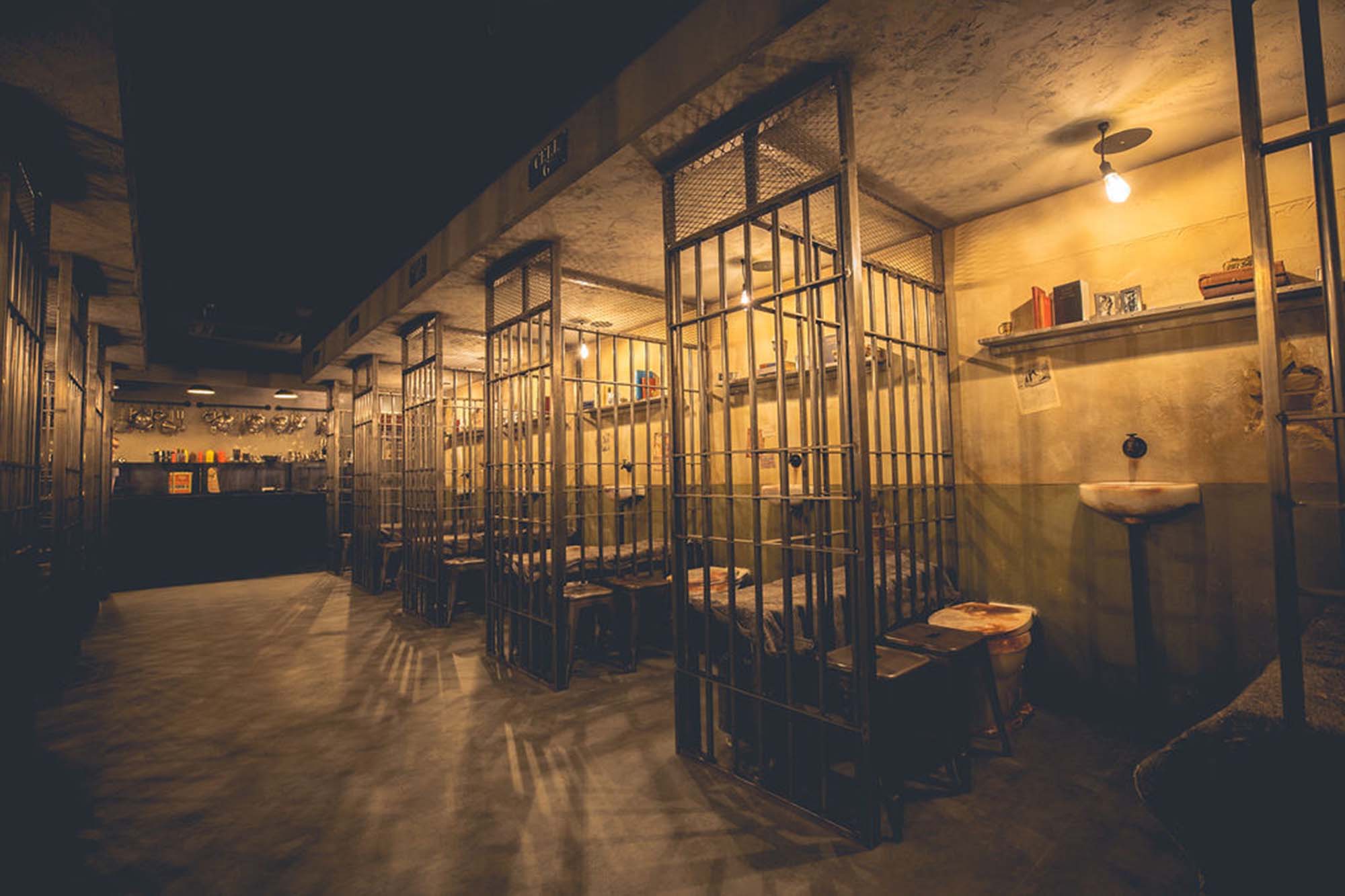 Prison cell interior design at Alcotraz - interactive jail cocktail bar for fun activities.