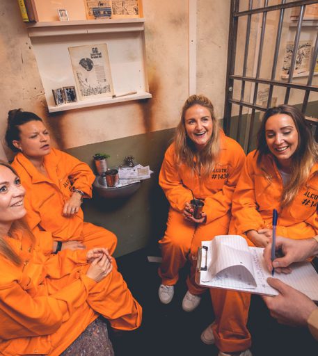 Inmates in Manchester Alcotraz prison cell - authentic details in this immersive cocktail bar for unique activity nights.