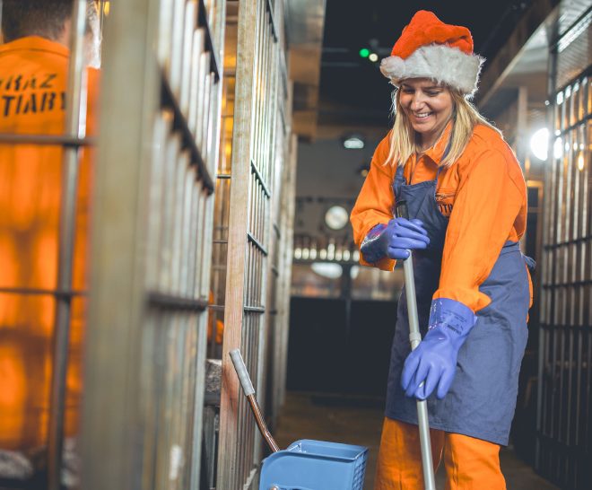 Inmate celebrating Christmas at Alcotraz- festive immersive cocktail experience with holiday theming for seasonal celebrations.