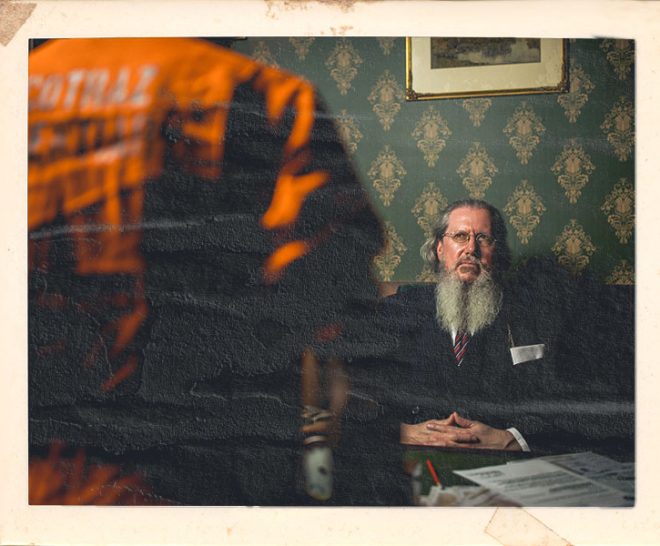 Warden character with customers at Alcotraz Bristol - prison-themed immersive cocktail bar experience for nights out.