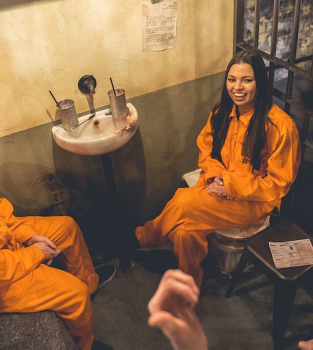 Couple on date night at Alcotraz - romantic prison-themed immersive cocktail experience.
