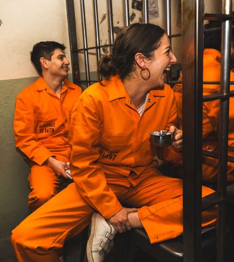 Couple on date night at Alcotraz - romantic setting in prison-themed immersive cocktail bar experience.