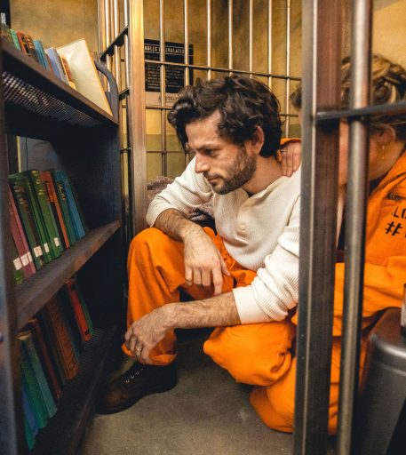 Couple on date night at Alcotraz - fun night out setting in prison-themed immersive cocktail bar.