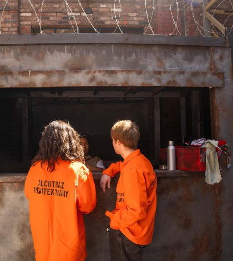 Inmates at prison yard bar at Alcotraz - interactive element of this immersive cocktail bar experience.